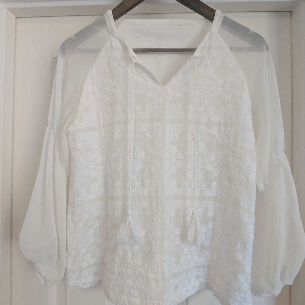 White blouse with embroidery.